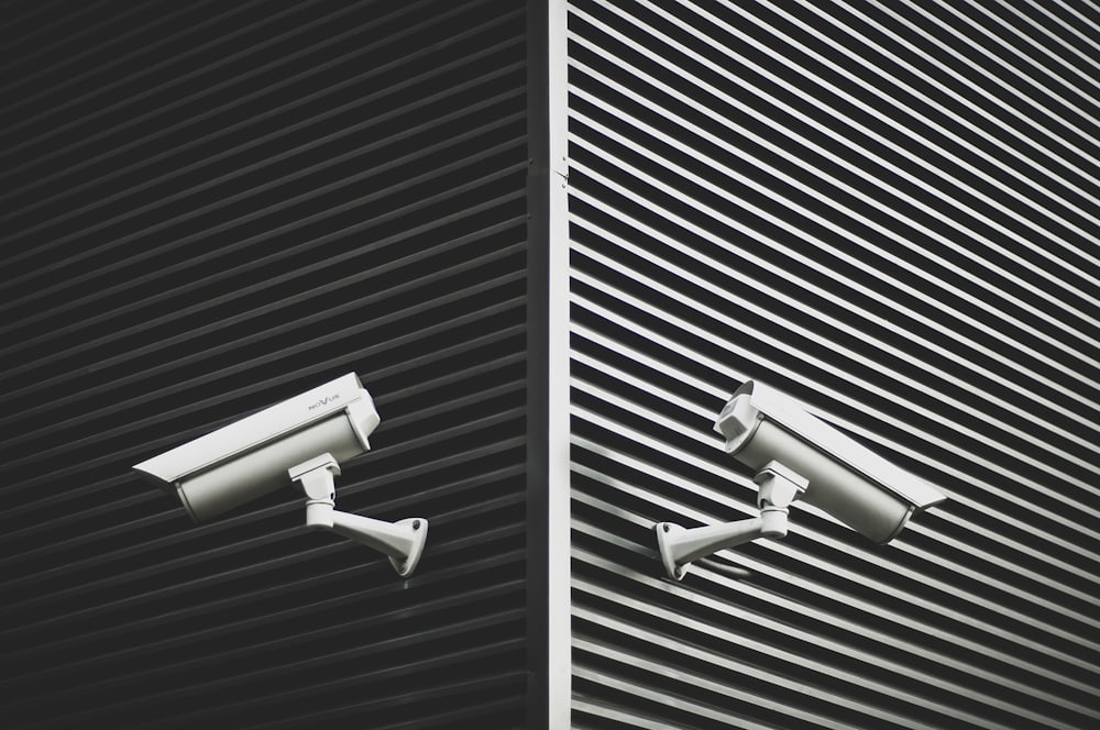 Two CCTV cameras mounted on a building exterior